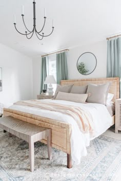 a bedroom with a large bed and a chandelier hanging from it's ceiling