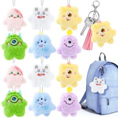 a bunch of small stuffed animals hanging from a keychain on a white background