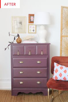 a purple dresser sitting next to a red chair in a room with pictures on the wall