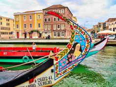 colorful boats are docked in the water next to buildings