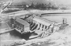 an aerial view of a large building next to a body of water