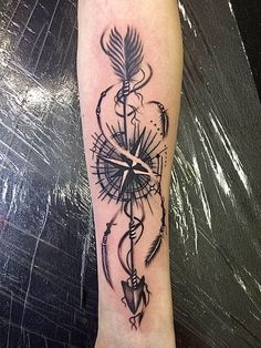 a black and white tattoo on the arm of a person with an arrow in it