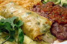 an enchilada with meat, beans and rice