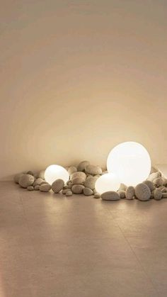 the light is shining on some rocks in the middle of a room with white walls and flooring