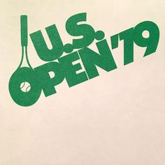 a tennis racket with the words us open written in green on a white background