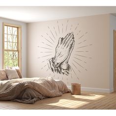 a bedroom with a bed and a wall mural depicting a praying hand on the wall