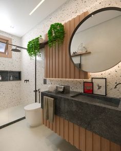 a bathroom with a sink, mirror and toilet in it's center piece is shown