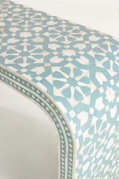 a blue and white table with an intricate design on it