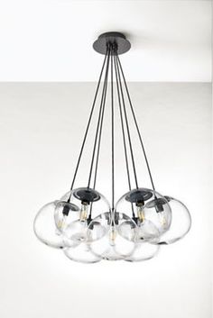 a chandelier with five glass balls hanging from the ceiling