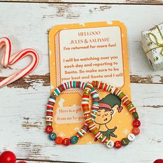 a christmas card with candy canes and candies next to it on a table