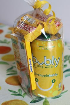 a can wrapped in plastic and tied with a yellow ribbon