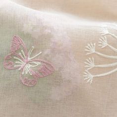 a close up of a pink and white butterfly on a light green background with flowers