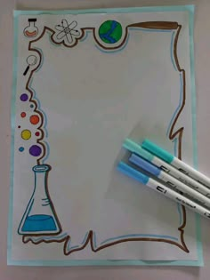 two markers are sitting on top of a sheet of paper with a science themed design