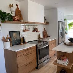 a kitchen with wooden cabinets and white counter tops, an oven and stove top in the center