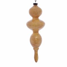 a wooden ornament hanging from a chain