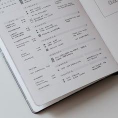 an open notebook with some writing on the page and numbers in each section that appear to be written