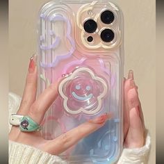 a woman holding up a phone case with an image of a flower on it