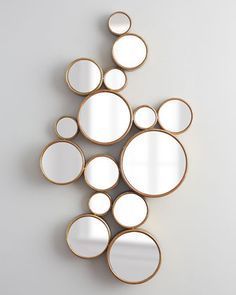 a group of mirrors sitting on top of a white wall