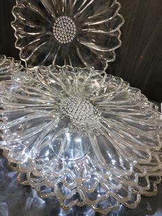 two glass dishes sitting on top of a table