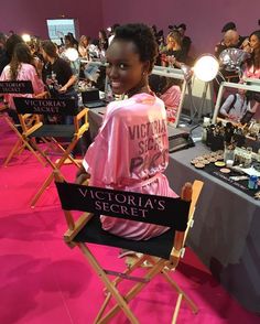 a woman sitting in a chair with victoria's secret written on it