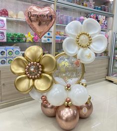 some balloons and flowers are on display in a store