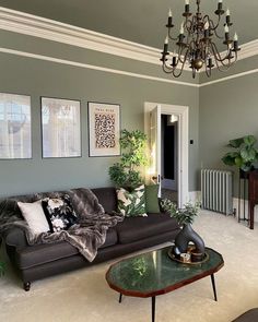 a living room filled with furniture and a chandelier