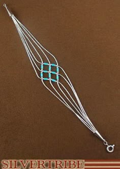 a silver and turquoise beaded necklace on a brown background with the words slivertribe written below it