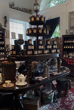 a room filled with lots of different types of coffee cups and saucers on top of tables