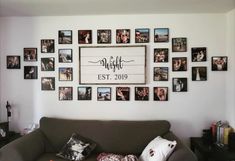 a living room filled with furniture and lots of pictures on the wall above it's couch