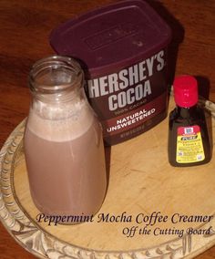 there is a jar of cocoa next to a container of ice cream on a plate