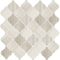 a white and grey tile with an intricate design on the back side, in shades of gray