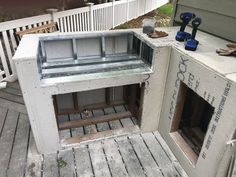 an outdoor dog house built into the side of a deck