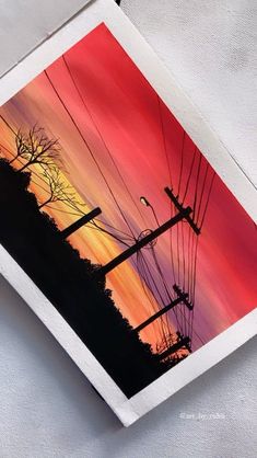 an image of power lines and telephone poles at sunset