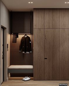 the closet is made up of wood and has a coat hanging on it