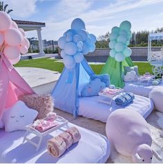 some balloons and stuffed animals are on display at a party or baby's first birthday