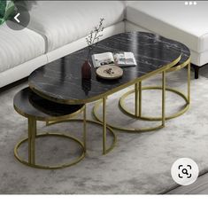 a table with two tables on it in front of a couch