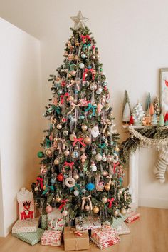 a decorated christmas tree with presents under it