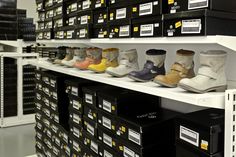 the shelves are filled with many pairs of shoes