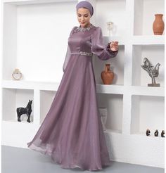 Modest Formal Satin Dress G531 Lilac ATTENTION: This item has a special return policy, different from our regular store policy. See details below. A classy evening dress perfect for formal events! Features a gemmed petal design along the neckline, puffed sleeves, and is made with sleek satin. FEATURES: - Fully lined - Satin fabric with organza overlay - Gemmed petal design along neckline - Puffed sleeves with a small flare at the wrist - Matching satin waistband with glitter along sides FABRIC Satin fabric made from 100% Polyester. Weighs about 2 lbs CARE: Dry clean only Do not machine wash Do not machine dry Do not bleach Made in Turkey SPECIAL RETURN POLICY FOR EVENING GOWNS The following return policy applies on all evening gowns: • Return must be requested within 48 hours of receiving Formal Satin Dress, Thobes Men, Classy Evening Dress, Organza Overlay, Sports Hijab, Small Wall Decor, Islamic Wall Decor, Hijab Pins, Islamic Decor