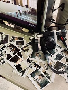 a camera sitting on top of a table next to pictures