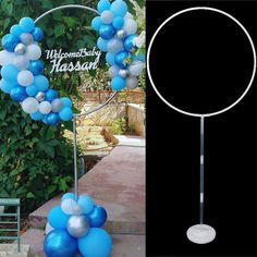 a blue and white balloon arch with balloons on it