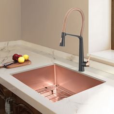 a kitchen sink with copper faucet and marble counter top