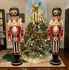 two nutcrackers standing in front of a christmas tree