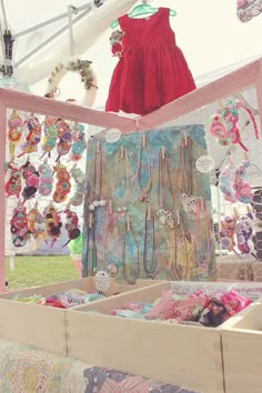 an assortment of necklaces on display in a tent