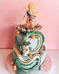 a birthday cake decorated with an image of a dragon and other things on top of it