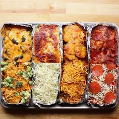 six different types of food in tins on a table