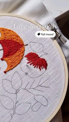 an embroidery project with two red and orange umbrellas on it's side, along with the text long short stitch fall mood