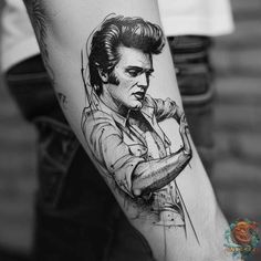 a man's arm with a drawing of elvis presley on it