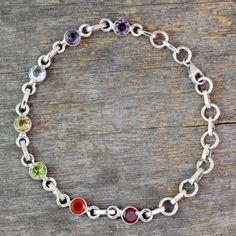 From Alok Jain this sterling silver bracelet links colorful gems associated with chakras. Set in sterling silver amethyst iolite citrine peridot garnet blue topaz and carnelian total 4.2 gemstone carats. Clear and light purple stones are associated with the 7th chakra (awareness and wisdom); the purple violet and indigo gems with 6th chakra (insight and perception) and the blue or light blue with the 5th that of communication and truth. Green and pink stones are for love and compassion linked to Bracelets With Beads, Orange Gem, Yellow Gems, Pink Stones, Black Gems, Chakra Jewelry, Purple Violet, Chakra Bracelet, Purple Stones