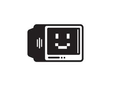 a black and white computer monitor with an emoticive face on it's screen